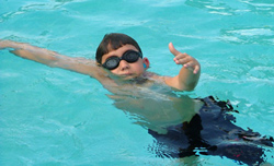 boy swims at an angle